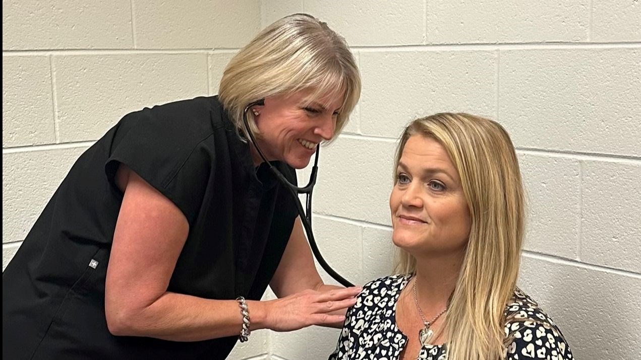 Nurse Dubiel helps a staff member